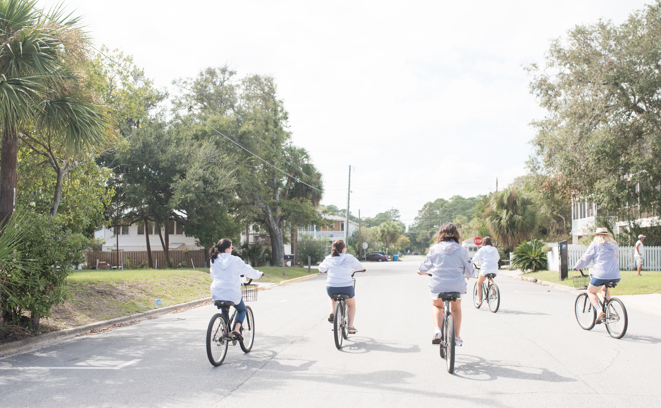 A group of five women riding bikes.
