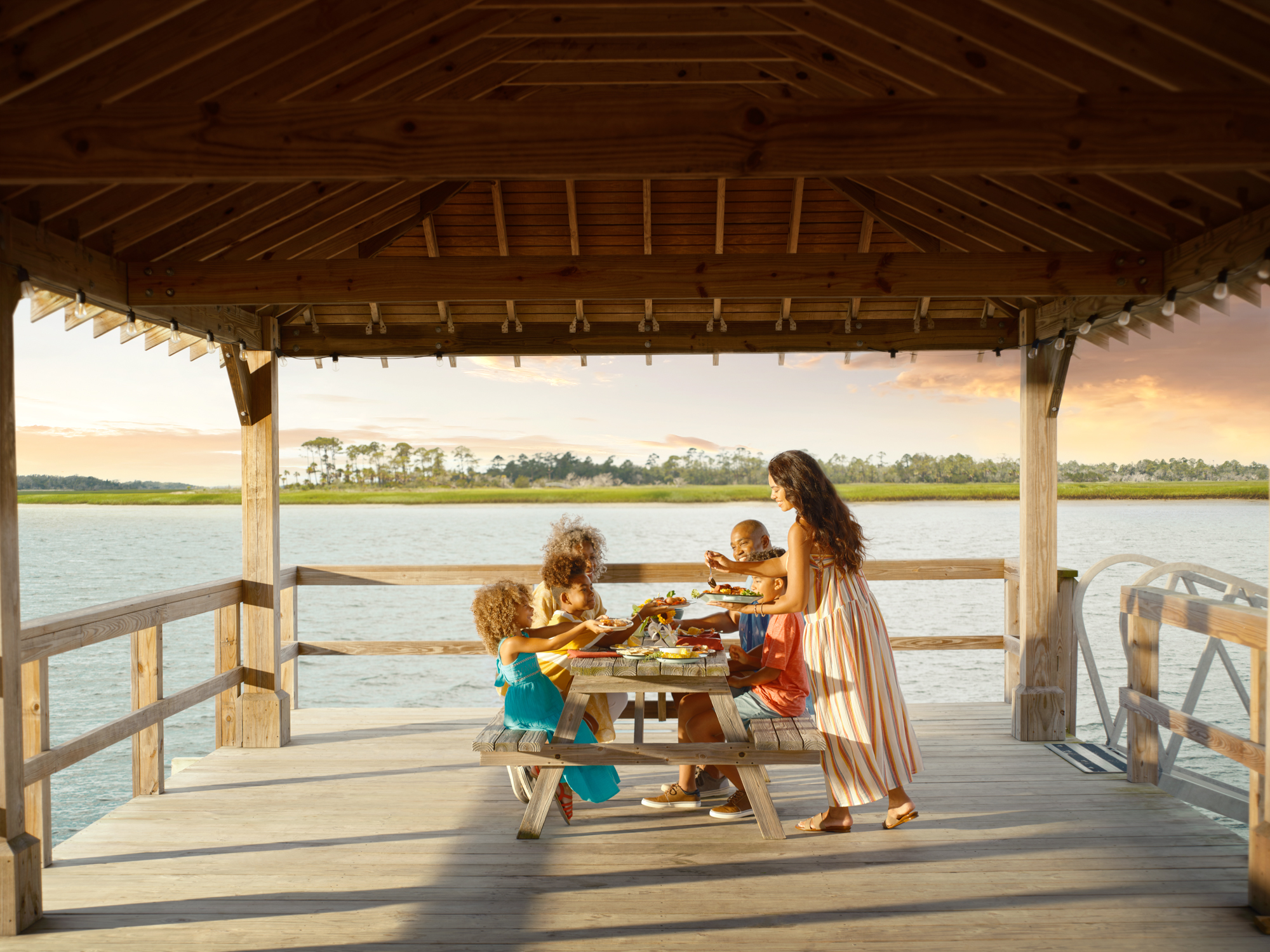 family dining on a dock