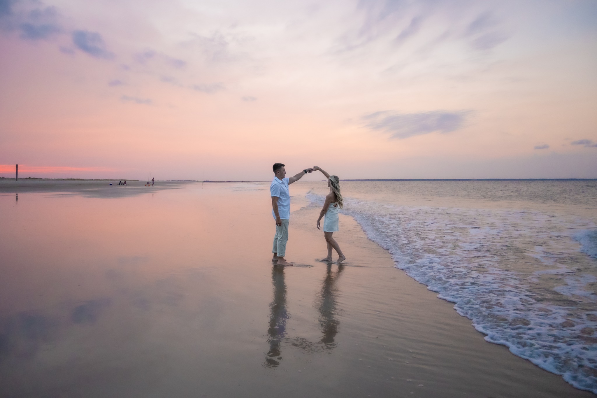couple dancing on the beach at sunset
