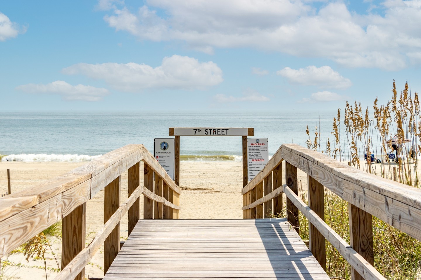A wooden boardwalk that leads to the beach.