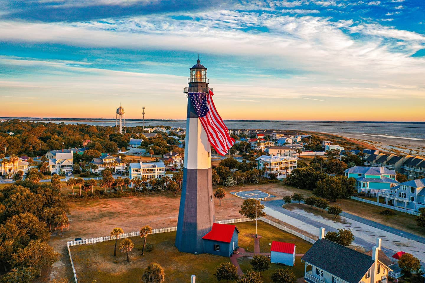 Drone shot of the American flag draped over the Tybee Island Lighthouse.