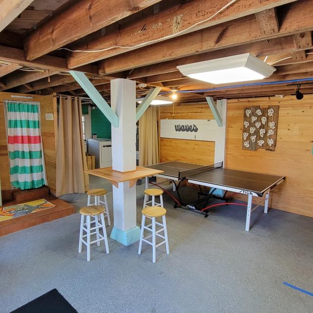 Basement recreational room with dart board and ping-pong table
