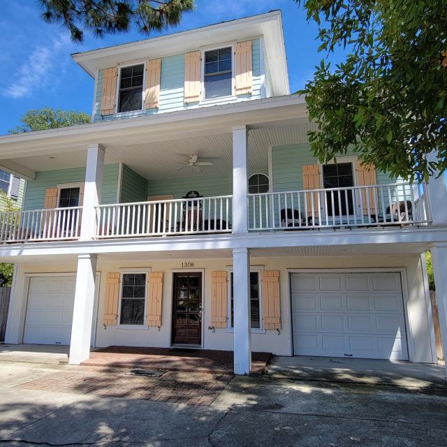 Exterior front view of house with driveway and garage