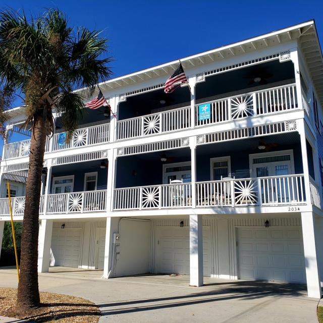 Exterior front view of home featuring two balconies