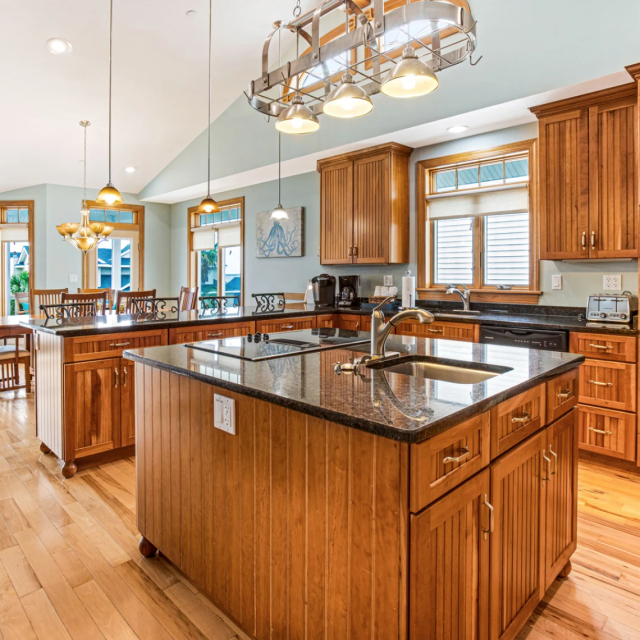 59 Captain’s View home’s gourmet kitchen with large island and stainless steel appliances