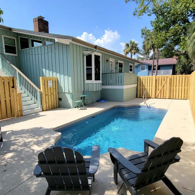 Backyard pool with seating at 604 Butler Avenue home on Tybee Island