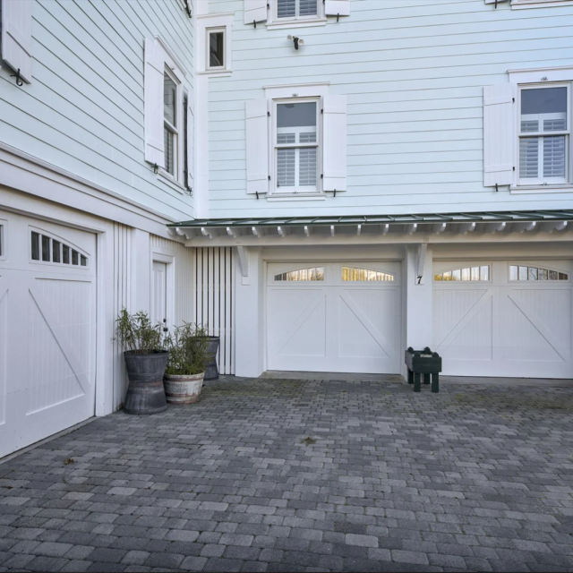 Private parking with multiple garage spaces and a large driveway