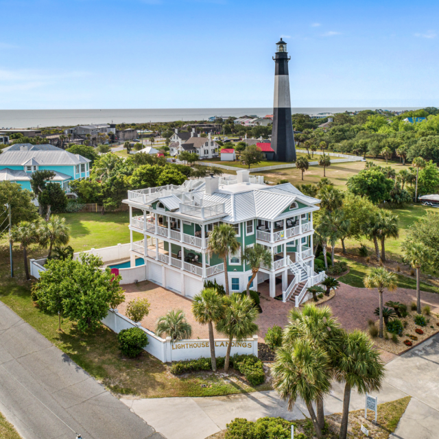 An aerial view of a home with a view of a lighthouse.