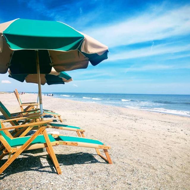 Beach chairs and umbrellas on the beach.