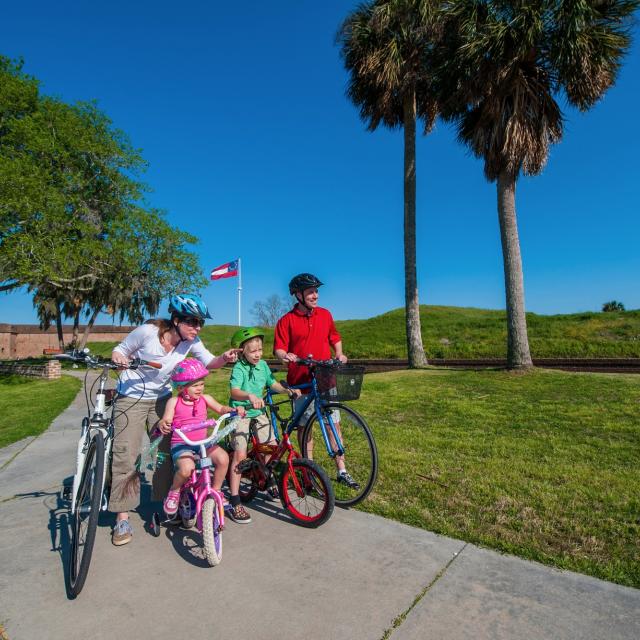 A family of four bike riding.