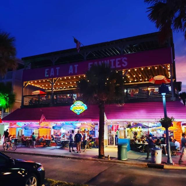 A nighttime exterior view of a restaurant.