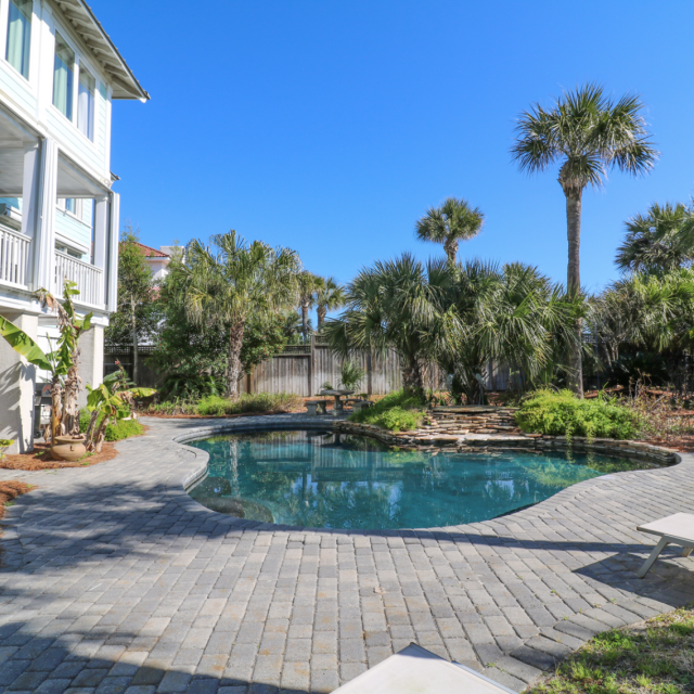 A beautiful multi-story home with a backyard pool.