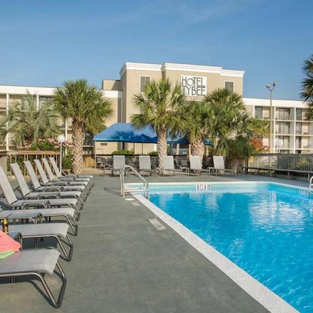 An outdoor hotel pool with seats around the pool.