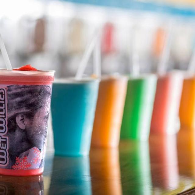 A row of colorful frozen daiquiris.