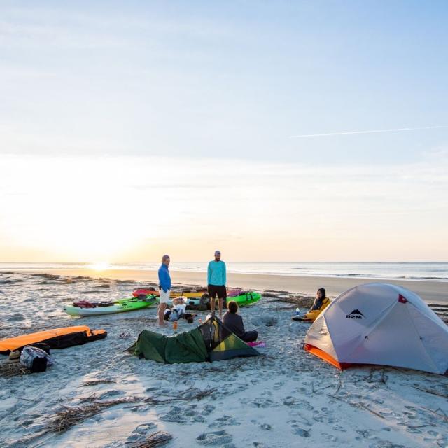 People camping on Little Tybee Island at sunset.