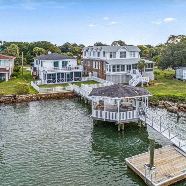 An aerial view of water views and numerous homes on the water.