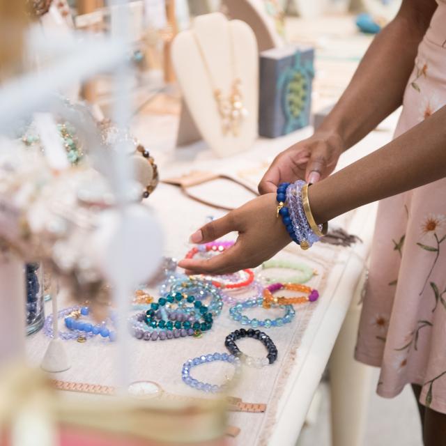 A person shopping for handmade jewelry.