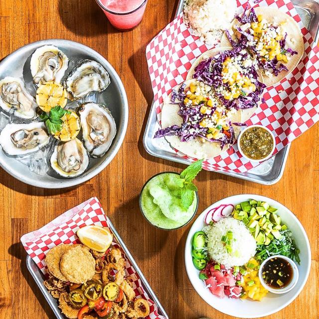 A table with multiple plates of food.
