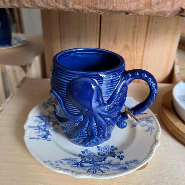 A navy blue ceramic coffee mug.