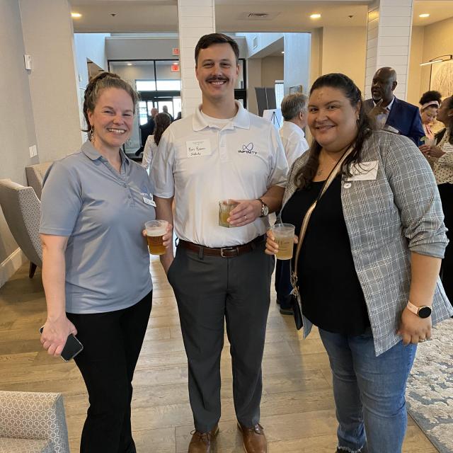 Group of three people posing for a photo