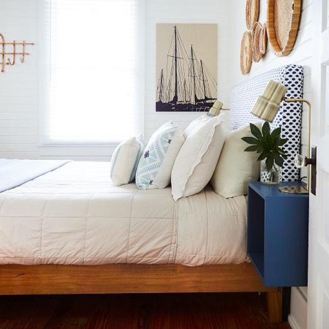 A view of a bed in a nautical-themed bedroom.