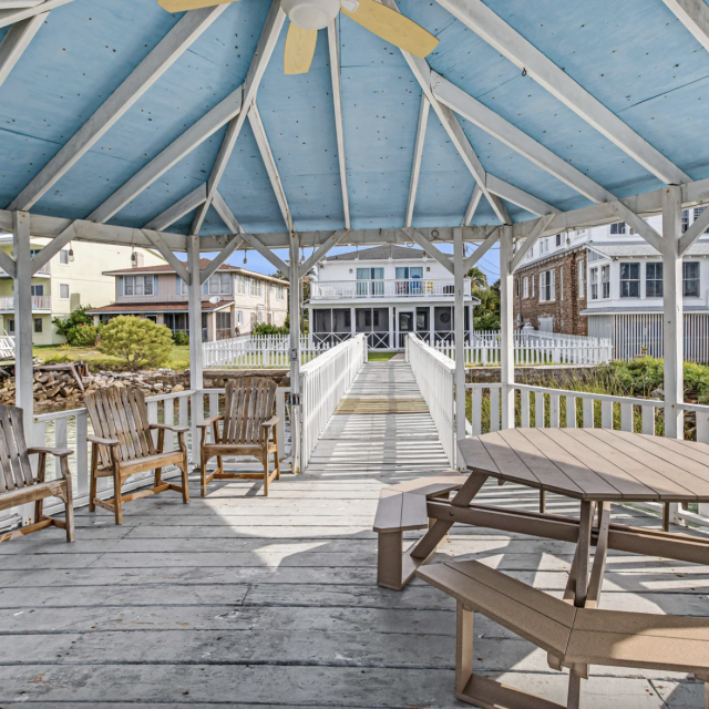 Outdoor dock pavilion with seating and ceiling fan