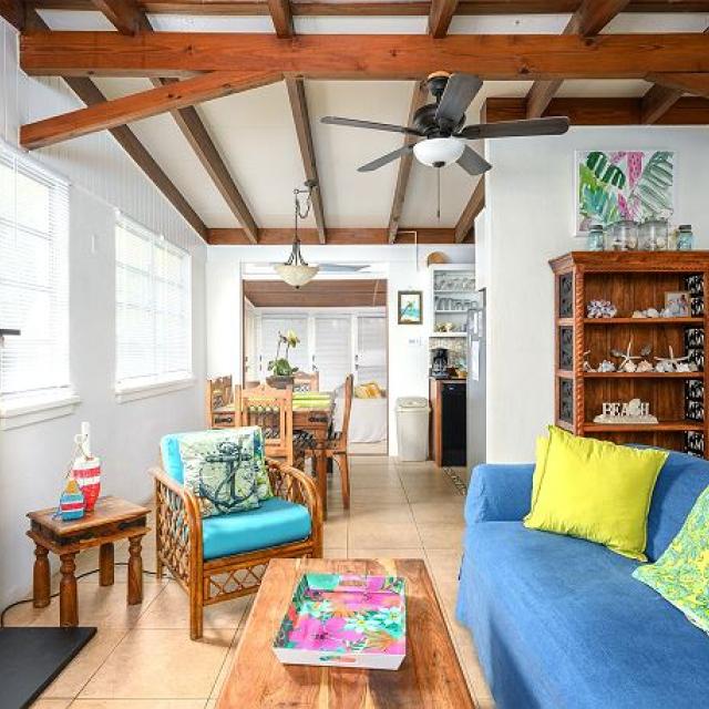 A spacious living room with bright colored furniture and a fireplace
