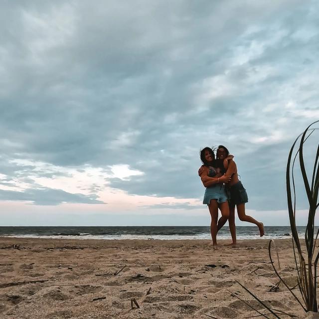 two girls hugging on beach