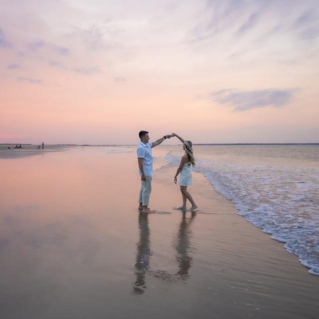 couple dancing on the beach at sunset