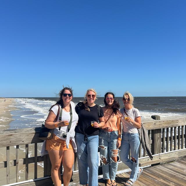 group of girls smiling on the pier
