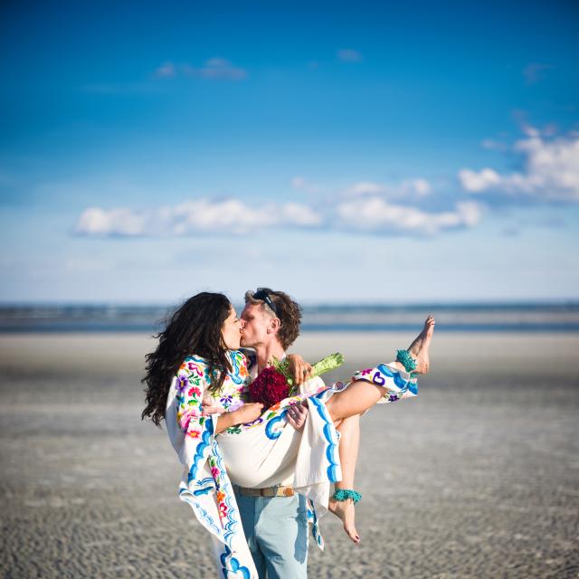 funky beach wedding couple kissing