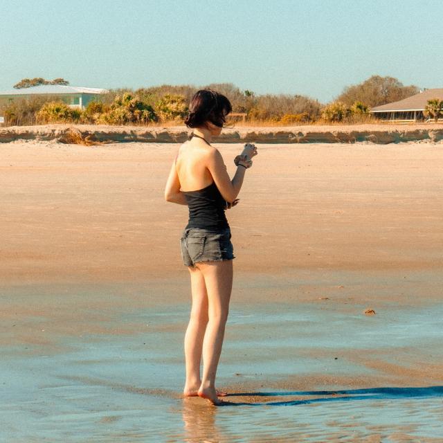 A woman standing on the beach.