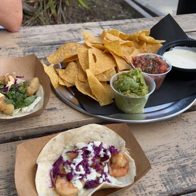 Plates of food displayed on an outdoor picnic table.