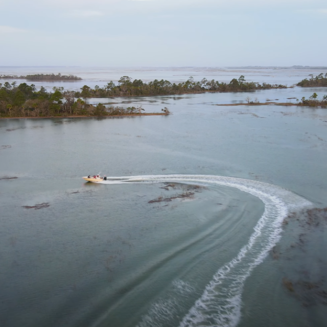 A small charter boat sailing along Tybee Island, GA.