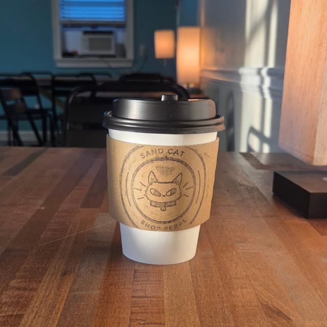 An insulated to-go coffee in a coffee shop.