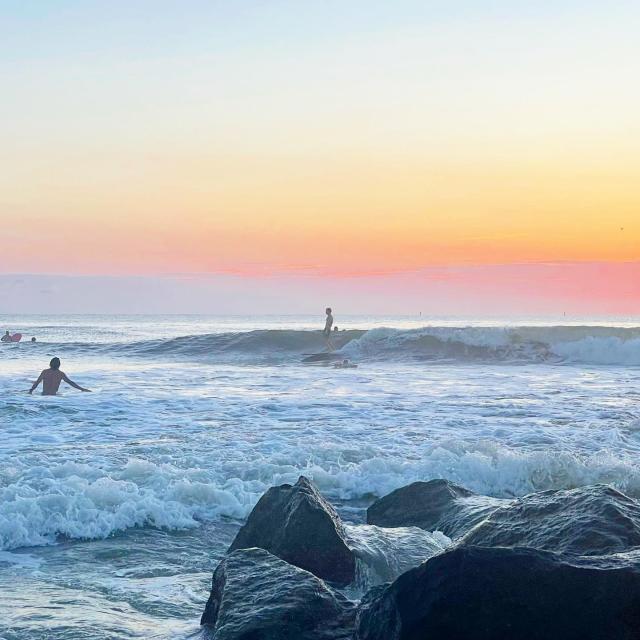 Surfers in the ocean on Tybee Island, GA.