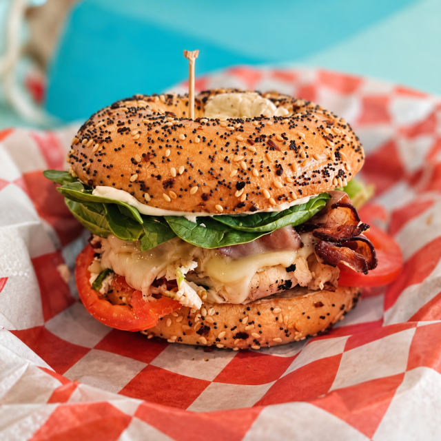 A loaded turkey bagel sandwich.