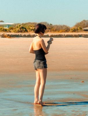 A woman standing on the beach.
