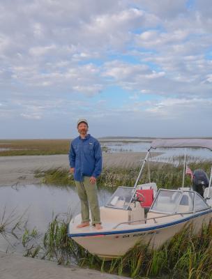 A captain standing on the bow of a boat on Tybee Island, GA.