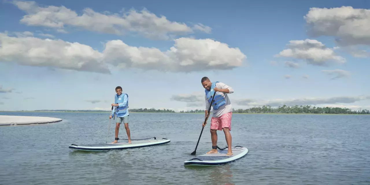 Father and son paddleboarding