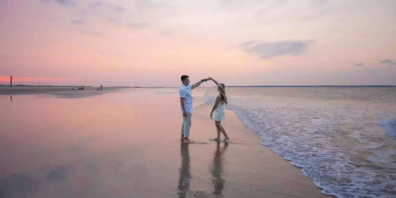 couple dancing on the beach at sunset