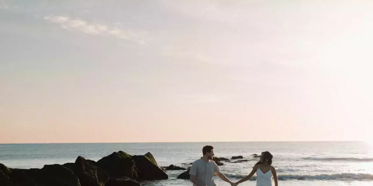couple walking along the shore
