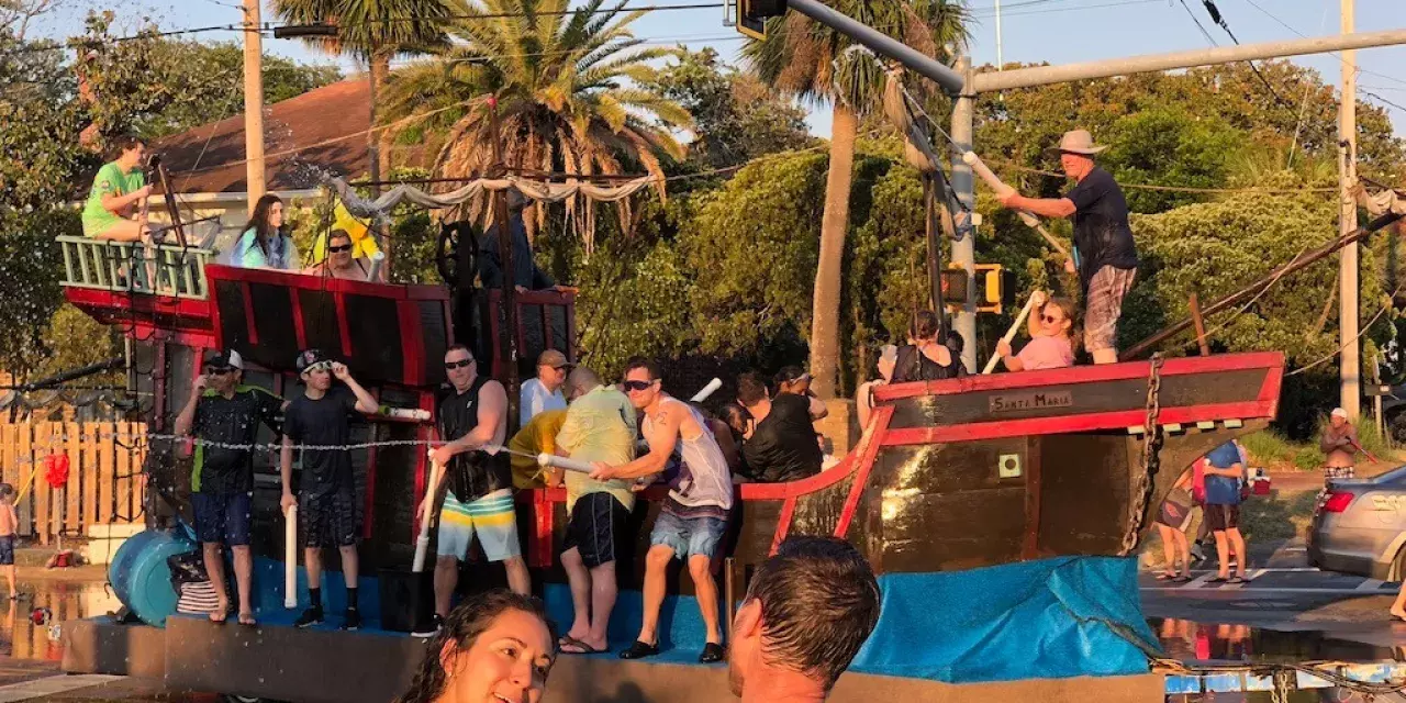 People on parade floats using water guns