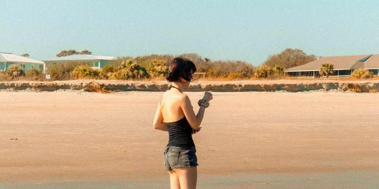 A woman standing on the beach.