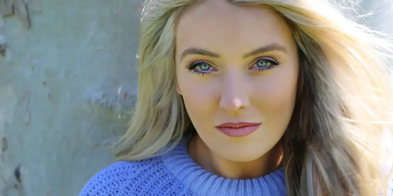 Portrait of Dublin singer Chloe Agnew outdoors wearing a blue sweater.
