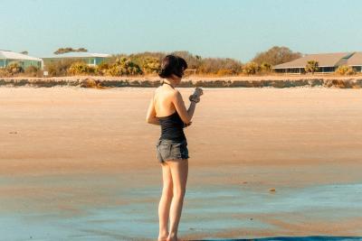A woman standing on the beach.
