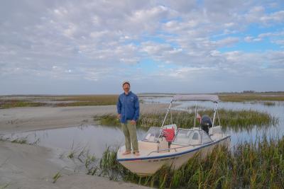 A captain standing on the bow of a boat on Tybee Island, GA.