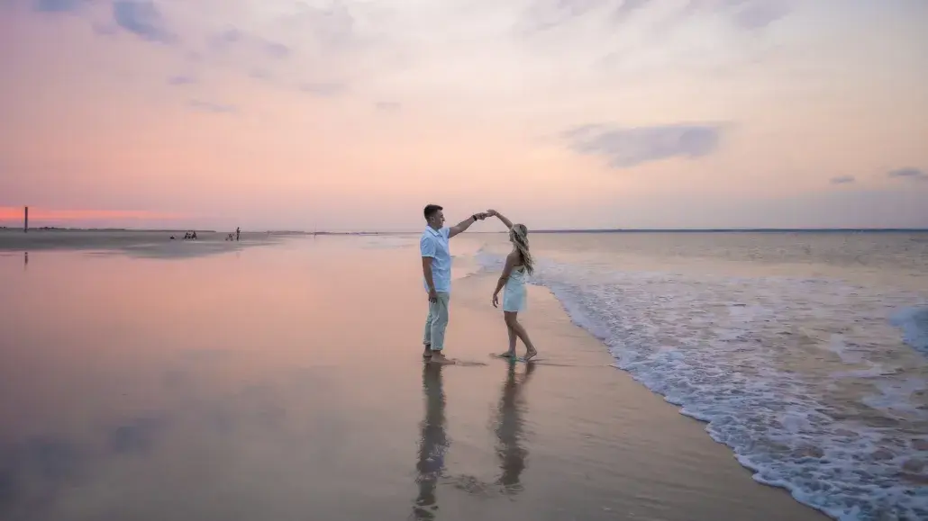 couple dancing on the beach at sunset