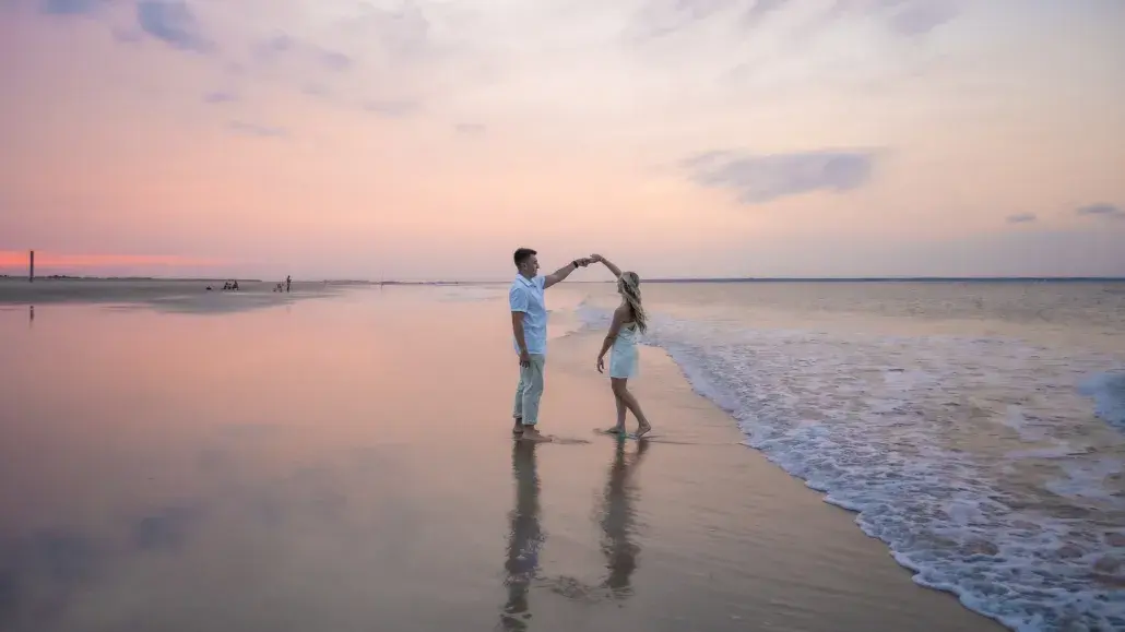 couple dancing on the beach at sunset