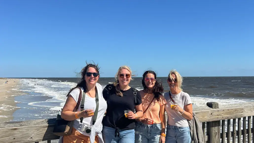 group of girls smiling on the pier
